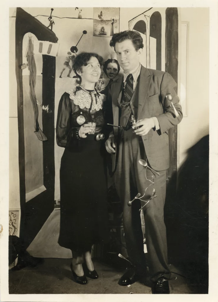 Black and white photograph from the early 1940s of a woman and a man, both with light skin tones, formally dressed and standing next to each other.