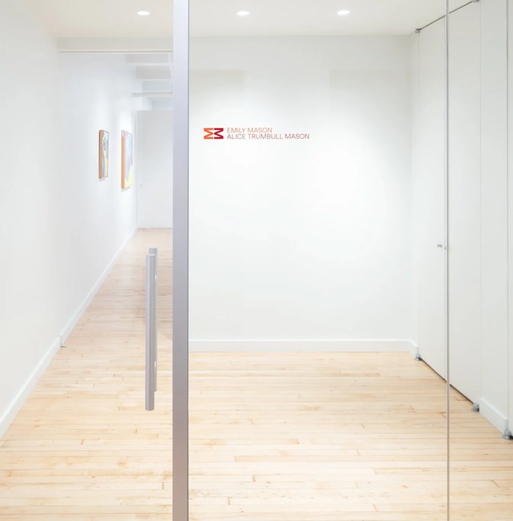 Image_5 A photograph of glass doors with the text "The Emily Mason and Alice Trumbull Foundation" printed on them in red.